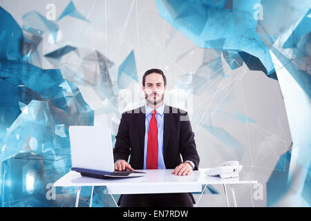 Composite image of businesswoman sitting at desk Banque D'Images