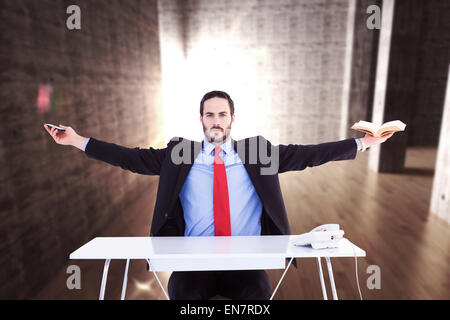 Composite image of businesswoman sitting with arms outstretched Banque D'Images