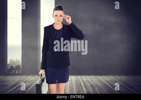 Composite image of businesswoman in suit carrying briefcase Banque D'Images