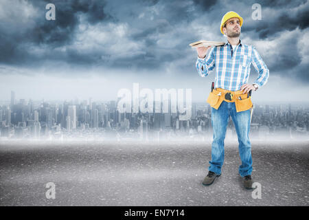 Composite image of worker carrying wooden planks Banque D'Images