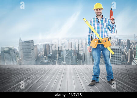 Image composite de portrait of smiling repairman avec des outils Banque D'Images