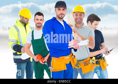 Image composite de handyman in blue dans l'ensemble writing on clipboard Banque D'Images