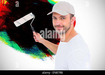 Image composite de handyman holding paint roller Banque D'Images