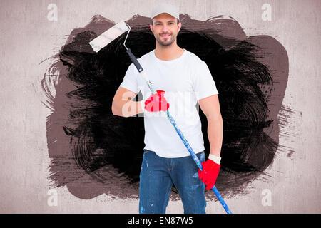 Image composite de handyman holding paint roller Banque D'Images