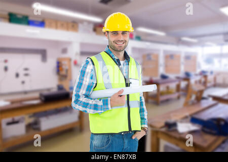 Image composite de portrait of smiling architect holding blueprint Banque D'Images