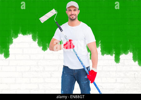 Image composite de handyman holding paint roller Banque D'Images