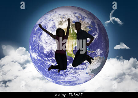 Image composite de cheerful young couple jumping Banque D'Images