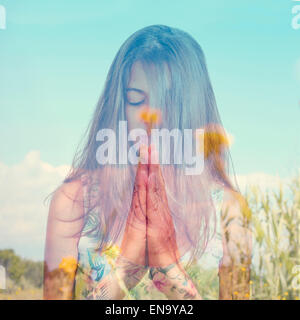 Double exposition d'une jeune femme brune en méditant et un paysage paisible avec des fleurs jaunes Banque D'Images