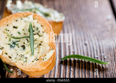 Baguette (au Beurre d'herbes et d'ail) sur fond de bois rustique Banque D'Images