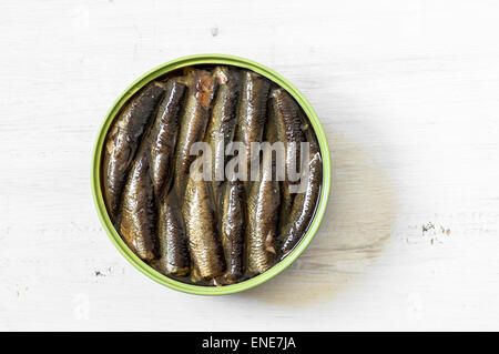 Boîte de sardines fumées sur une table en bois blanc Vue d'en haut. Banque D'Images