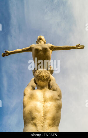 Les danseurs masculins et féminins en pierre contre un ciel bleu avec des nuages Banque D'Images