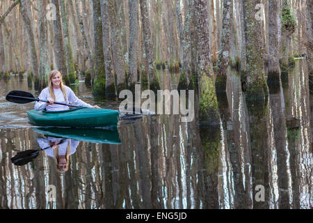 Caucasian woman rowing canoe river Banque D'Images