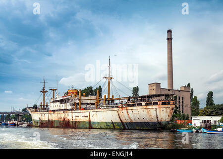 Vert et blanc, vieux bateau rouillé est amarré dans le port de Varna, Bulgarie. Vintage photo stylisée avec filtre de correction tonale Banque D'Images