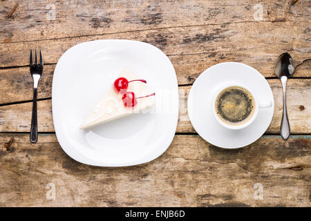 Voir l'image haut de morceau de gâteau au fromage avec du café. Gâteau avec cerise sur table en bois. L'arrière-plan du menu Banque D'Images