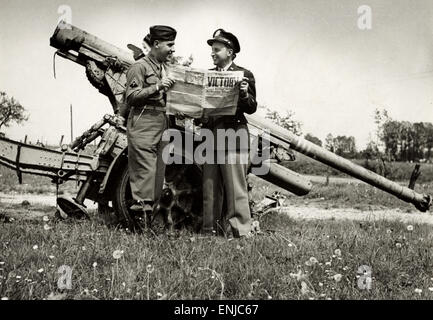 La victoire en Europe. Lire Soldats de la victoire, debout près d'un canon allemand de 88 mm à Verdun, France le jour de la VICTOIRE 1945 Banque D'Images