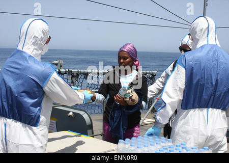 Document - Les soldats sur le pont de la frégate 'Hessen' donnez de l'eau à une femme, à 130 milles marins au large de l'île italienne de Lampedusa, 8 mai 2015. Dans leur premier déploiement en mer Méditerranée, Bundeswehr Marines avec deux navires naufragés sauvés autour de 430 réfugiés. Selon le commandement des opérations conjointes, la frégate 'Hessen' a eu environ 250 personnes à bord dans les eaux internationales, dont 30 femmes et 5 enfants. Les réfugiés avaient été voyager dans un bateau en bois, qui risquent de couler 50 kilomètres au large de la côte libyenne. PHOTO : Bundeswerhr/PAO Mittelmeer/dpa ( : pour l'EDI Banque D'Images