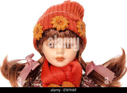 Vintage girl baby doll wearing red & brown dress Banque D'Images