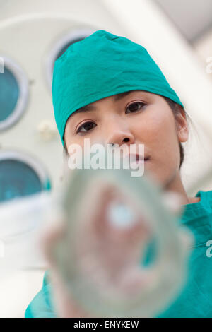 Infirmière sérieuse appliquant le masque à gaz à un patient Banque D'Images