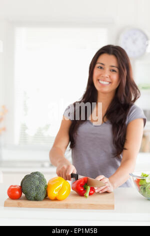 Charmante femme de cuire les légumes en position debout Banque D'Images