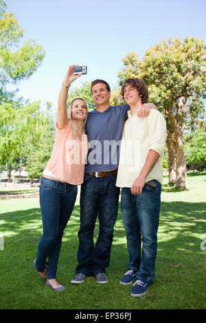 Trois étudiants en souriant une photos d'eux-mêmes Banque D'Images