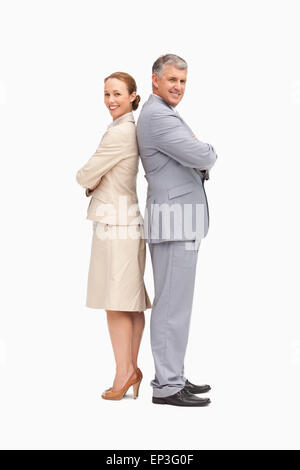 Portrait of smiling business people back to back Banque D'Images