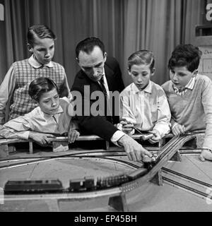 Ein Mann versammelt zum Ausbau von vier Jungen dans Modelleisenbahnanlage Hamburg, Deutschland 1950er Jahre. Un homme et quatre garçons Banque D'Images