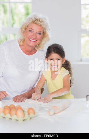 Petite-fille et grand-mère de préparer ensemble des biscuits Banque D'Images