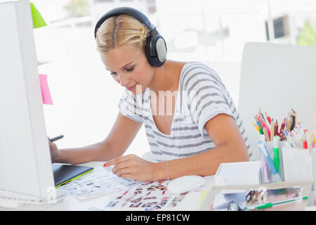 Cheerful photo editor working on contact sheets Banque D'Images