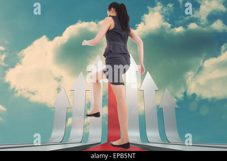 Composite image of businesswoman stepping up Banque D'Images