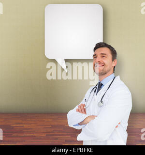 Image composite de handsome young doctor with arms crossed Banque D'Images