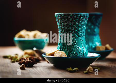 Du thé ou du vin chaud avec des épices diverses dans des verres traditionnels turcs sur fond de bois. Focus sélectif. Vue de la surface. Banque D'Images