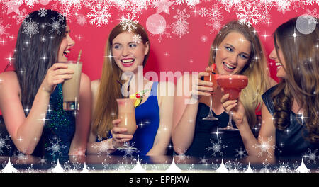 Image composite de four friends having a party holding cocktails Banque D'Images