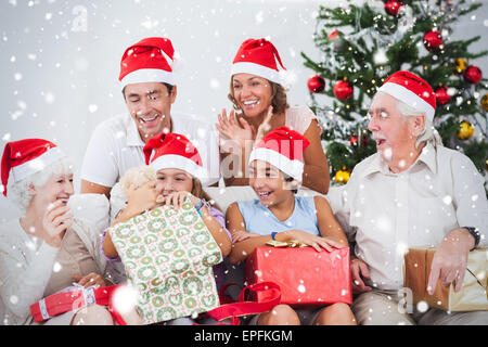 Image composite de little girl opening christmas present Banque D'Images