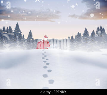Image composite de santa marcher dans la neige Banque D'Images