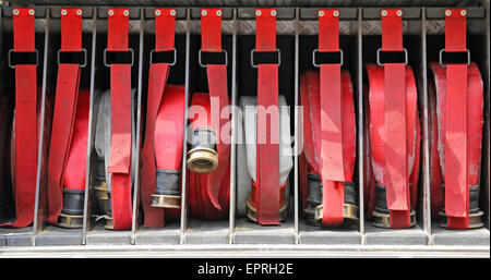 Les tuyaux d'eau rouge de pompiers au feu éteint Banque D'Images