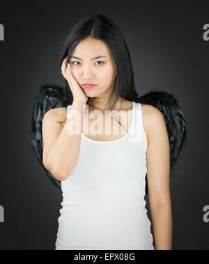Jolie Asian young adult woman in anges et demon Banque D'Images