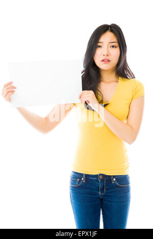Triste Asian young woman holding a blank placard Banque D'Images