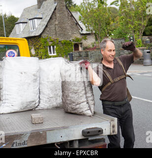 Charbon traditionnel livraison sacs homme ouvert du charbon de lorry Banque D'Images