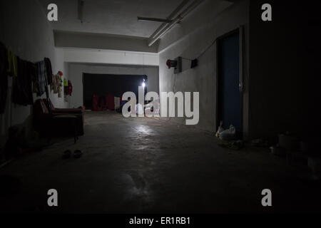 Langkawi, Malaisie. 20 mai, 2015. Vue depuis l'intérieur de la télévision dans le bâtiment abandonné de Langkawi.à Kuah district, pas trop loin de la zone touristique de l'île de Langkawi, à proximité de l'aéroport.9 hommes Rohingyas ayant entre 15 et 26 ans, partager un plat à l'intérieur d'un bâtiment abandonné appartenant à leur employeur qu'ils travaillent pour.Après avoir fui leur pays (Myanmar) ''aidé'' par les contrebandiers habituellement à partir de la Thaïlande, et les dépenses pour certains d'entre eux plus de 10 mois à voyager en bateau, ou à pied à l'intérieur de la jungle sauvage, adoptée par l'Thai camp, traités comme des esclaves, ont vu beaucoup d'o Banque D'Images