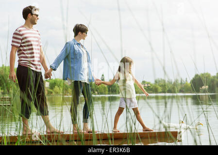 Family holding hands on dock Banque D'Images