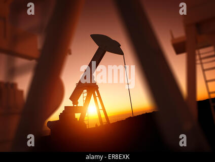 L'industrie du pétrole et de l'énergie. Un domaine de la pompe à huile contre un coucher de soleil. Les prix du pétrole, l'énergie et des produits économiques. Banque D'Images