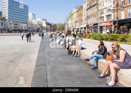 Des gens assis profitant du soleil du printemps dans l'ancienne place du marché, le centre-ville de Nottingham, Angleterre, RU Banque D'Images