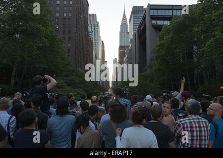 New York, USA. 30 mai, 2015. Les gens attendent de prendre des photos de "anhattanhenge» dans le Manhattan, New York, États-Unis, le 30 mai 2015. Les touristes, les habitants et les banlieusards attendu pour prendre des photos de l'effet "anhattanhenge» mais ont été contrecarrés par les nuages samedi. Le Manhattanhenge renvoie à la deux fois par année au cours de laquelle la circonstance coucher de soleil soit parfaitement aligné avec les rues est-ouest de New York. © Muzi Li/Xinhua/Alamy Live News Banque D'Images