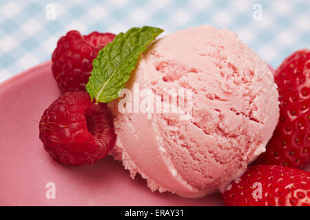 Boule de glace à la fraise faite maison avec des feuilles de menthe poivrée Banque D'Images