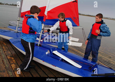 Les jeunes de la décolleteuse de voile dériveurs à Hengistbury Head Centre, Dorset. Un bateau britannique à l'eau bateaux canot sports loisirs sport Banque D'Images