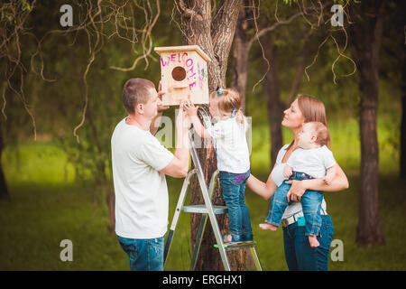 Famille heureuse avec Wooden birdhouse Banque D'Images