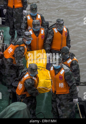 Jianli, Chine. 3 juin, 2015. Les sauveteurs tentent de transporter un corps de la victime à l'emplacement de la navire renversé dans la section Jianli de la rivière Yangtze, le centre de la Chine, Province de Hubei. Il y a eu plus de 450 personnes à bord du navire à passagers, le Eastern Star lorsqu'il sombra, "dans une ou deux minutes après avoir été frappé par une tornade au Jianli, Province de Hubei, selon le capitaine du navire et le chef mécanicien, qui ont tous deux survécu. Source : Xinhua/Alamy Live News Banque D'Images