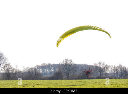 Avec l'homme qui monte en parapente dans le ciel Banque D'Images