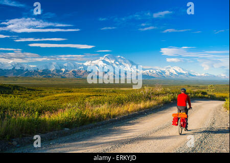 Un homme le cyclotourisme dans le Parc National Denali avec Mt. McKinley dans l'arrière-plan, l'intérieur de l'Alaska, l'été Banque D'Images