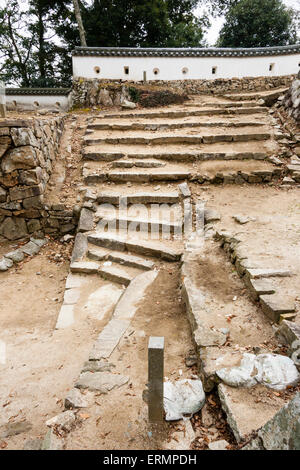 Ruines de Takahashi, château de Bitchu Matsuyama au Japon. La porte de l'OTE-Yaguramon, avec des marches menant au chemin du château, déambulées par le mur de la neribei dobei. Banque D'Images